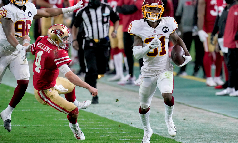 Washington Football Team strong safety Kamren Curl (31) runs back an interception for a touchdown as San Francisco 49ers quarterback Nick Mullens (4) tries to defend during the second half of an NFL football game, Sunday, Dec. 13, 2020, in Glendale, Ariz. (AP Photo/Ross D. Franklin)